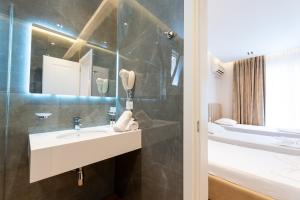 a bathroom with a sink and a shower at Hotel Vila Mare in Durrës +88 photos