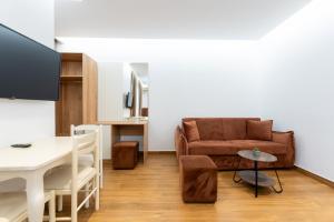 a living room with a couch and a table at Hotel Vila Mare in Durrës