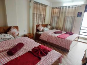 a bedroom with two beds with bows on them at grace homestay in Darjeeling