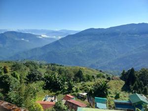 a view of a valley with mountains in the background at grace homestay in Darjeeling