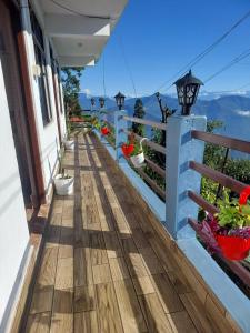 a balcony of a house with a view of the mountains at grace homestay in Darjeeling