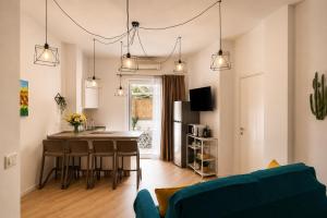 a kitchen and living room with a table and chairs at Yellow Apartment in Bari