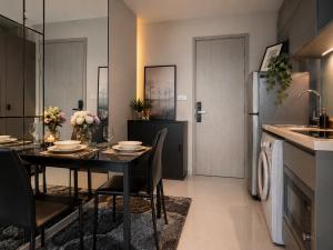 a dining room with a table and a kitchen at Ultra luxury Condo in Bangkok