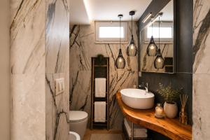a bathroom with a sink and a toilet and a mirror at Yellow Apartment in Bari +16 photos