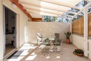 a patio with a table and chairs on it at Yellow Apartment in Bari