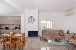 a living room with a couch and a table at Pastida Olive Home in Pastida
