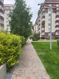 a brick path in a park with buildings at Golden Era Relax in Odesa