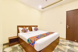 a bedroom with a large bed in a room at FabHotel Shivalika in Jaipur
