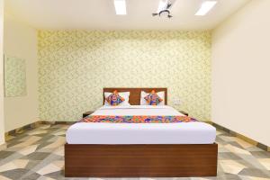 a bedroom with a large bed in a room at FabHotel Shivalika in Jaipur