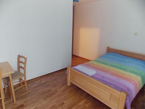 a bedroom with a bed and a table and a chair at Hostel Kavala in Belgrade
