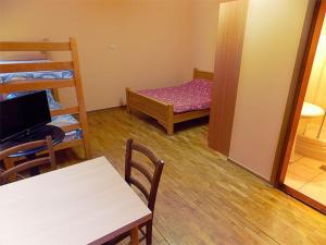 a room with two bunk beds and a table and chairs at Hostel Kavala in Belgrade