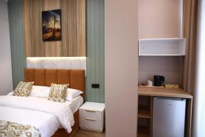 a small bedroom with a bed and a desk at Isra City Hotel in Dushanbe