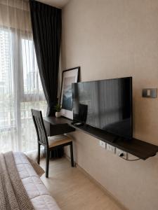 a hotel room with a large flat screen tv on the wall at Ultra luxury Condo in Bangkok +4 photos