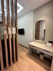 a dressing room with a mirror and a desk at Isra City Hotel in Dushanbe