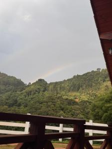 a view of the mountains from the porch of a house at Chalé Recanto do Quilombo - MV in Camanducaia +31 photos