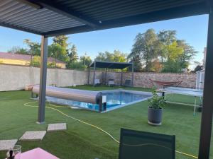 a backyard with a swimming pool and a gazebo at Maison Galland in Lapalisse