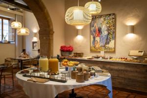a table with a buffet of food in a restaurant at Hotel Nou Romà in Denia +45 photos