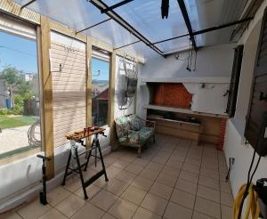 a screened in porch with a chair and a table at Gaillarde in Brive-la-Gaillarde