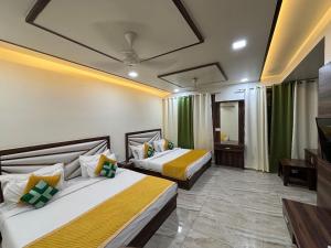 a hotel room with two beds and a television at The Crown Hotel Agra near Taj Mahal in Agra +55 photos