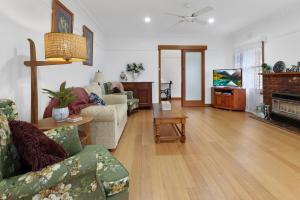 a living room with a couch and a table at Retro Retreat in Highton