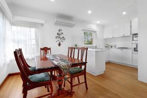 a kitchen and dining room with a table and chairs at Retro Retreat in Highton