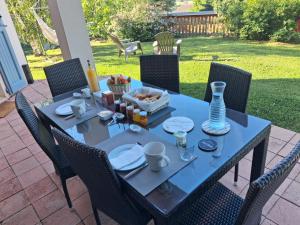 a blue table with a tray of food on it at Les Logis de Léa in Saint-Beauzély
