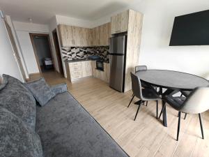 a living room with a couch and a table at Episkopos Escape in Nikiana