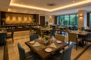 a dining room with tables and chairs and a restaurant at Green Villa in Nagpur