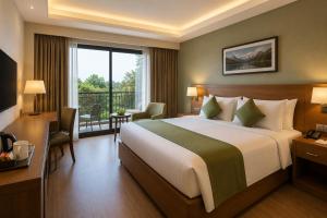 a hotel room with a bed and a balcony at Green Villa in Nagpur