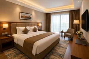 a hotel room with a large bed and a television at Green Villa in Nagpur