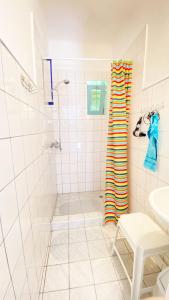 a white bathroom with a shower and a sink at Park Apartman in Sály +11 photos