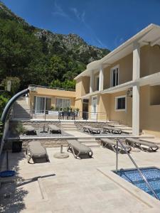 a building with a swimming pool and a resort at Luxury Studio Apartment with Sea View & Heated Pool in Kotor