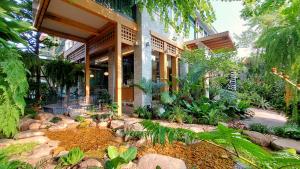 a house with a garden in front of it at SHAN Villas Sukhumvit ฌานวิลล่า สุขุมวิท in Bangkok