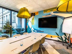 a meeting room with a mural on the wall at ibis Styles Warszawa Centrum in Warsaw