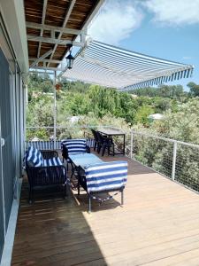 a patio with chairs and tables on a deck at Adrasan village house in Kumluca