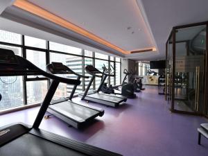 a gym with several tread machines in a room with windows at Mercure Chengdu Chunxi Taikoo Li -Walk to Pedestrian Street in Chengdu