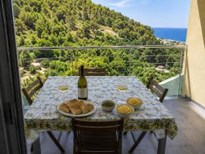 a table with a bottle of wine and food on a balcony at BellaVista - Vallecrosia in Vallecrosia +2 photos