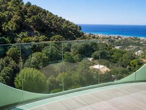 a glass house with a view of the ocean at BellaVista - Vallecrosia in Vallecrosia