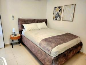 a bedroom with a large bed with a brown headboard at וילה נחל טביה in Arad +19 photos