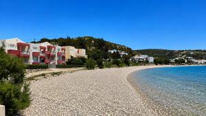 a view of a beach with houses and the water at Venetiko rooms in Chios