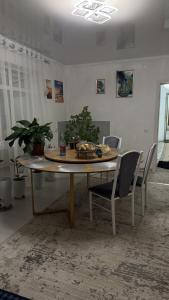 a table in a room with chairs and a table with food on it at Friendly House in Bokonbayevo +2 photos