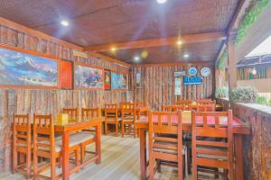 a dining room with wooden tables and chairs at Hotel Lekali Homes in Kathmandu