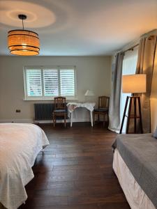 a bedroom with a bed and a table and chairs at Boycott House in Shalstone