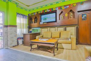 a living room with a couch and a tv at Hotel Lekali Homes in Kathmandu