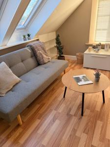 a living room with a couch and a table at Krummeled Rooms & Shelter by the forest in Hasle
