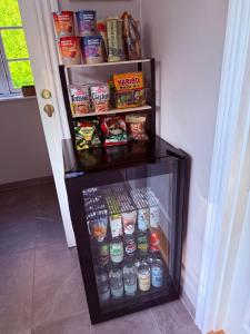 a refrigerator filled with lots of food and drinks at Krummeled Rooms & Shelter by the forest in Hasle