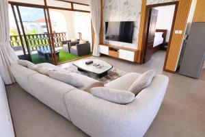 a living room with a couch and a television at Sultan palace Luxury Two bedrooms in Kilifi