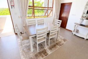 a dining room with a wooden table and chairs at Sultan palace Luxury Two bedrooms in Kilifi