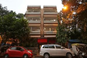 two cars parked in front of a building at Hotel Penguin International in Kolkata +11 photos