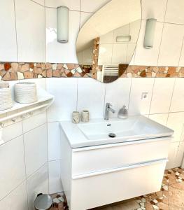 a bathroom with a sink and a mirror at Haus Landzauber in Ramsau am Dachstein +34 photos
